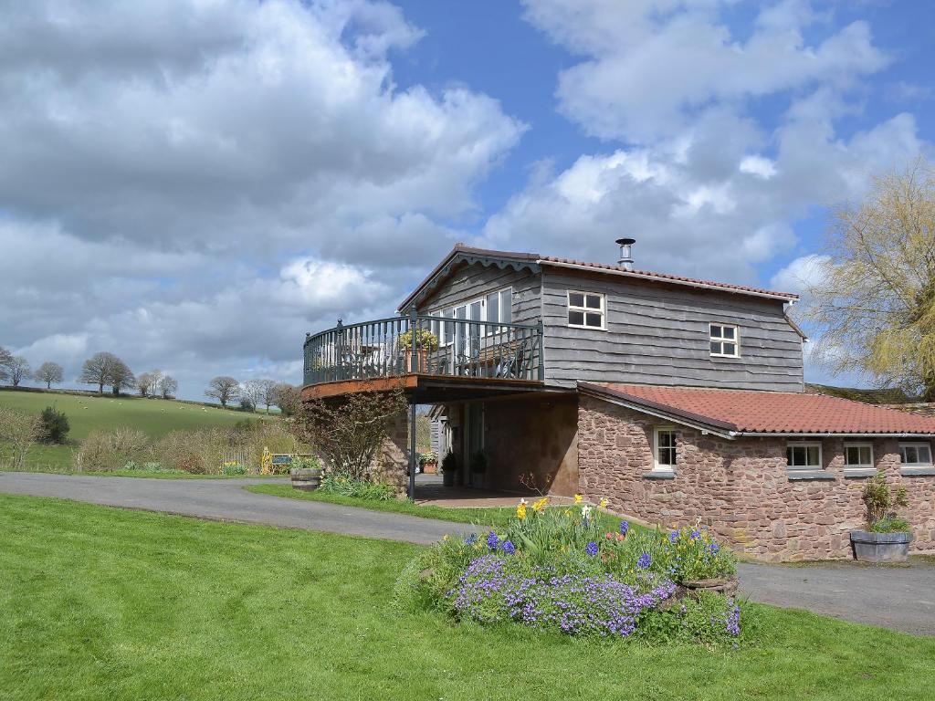 a house with a balcony on top of it at Bugatti House in Bosbury