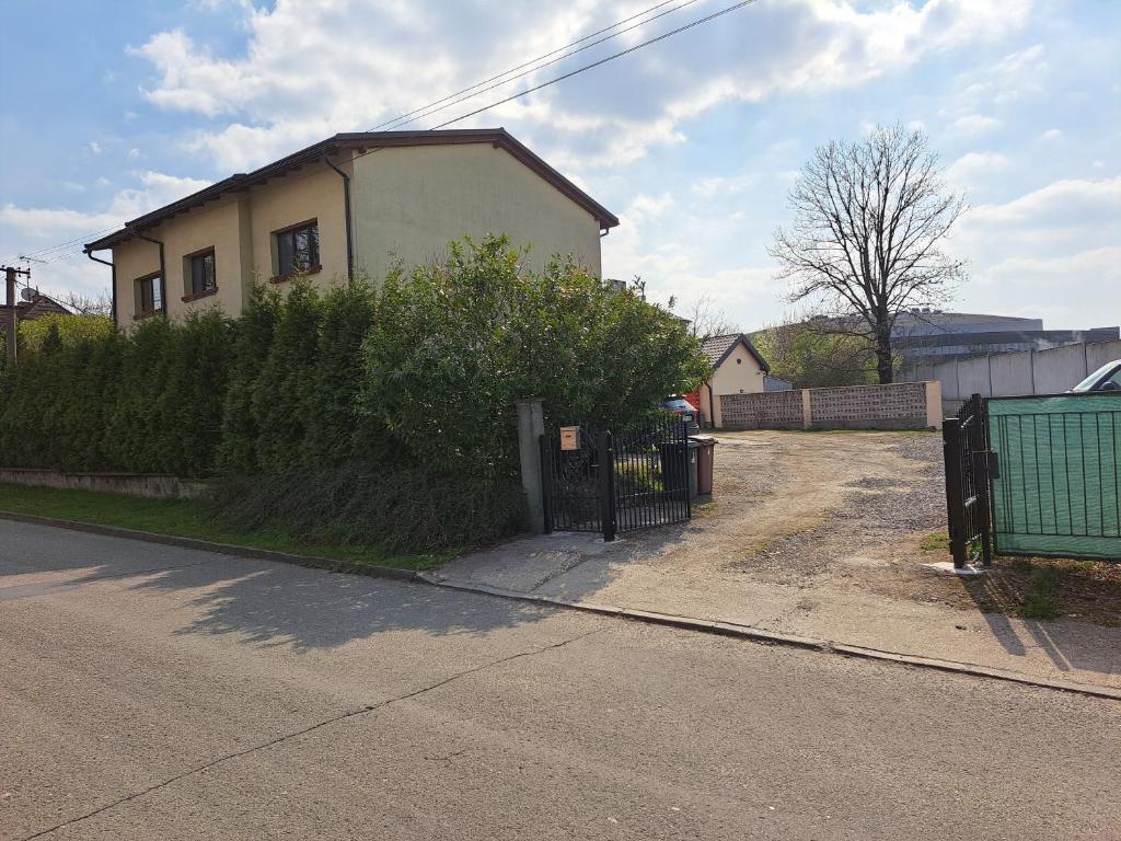 a house on the side of a street with a fence at Apartmán Bezručka in Třinec