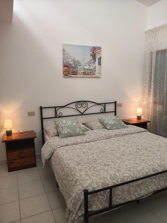 a bedroom with a large bed and two night stands at Agriturismo Il Cipresso in Vada