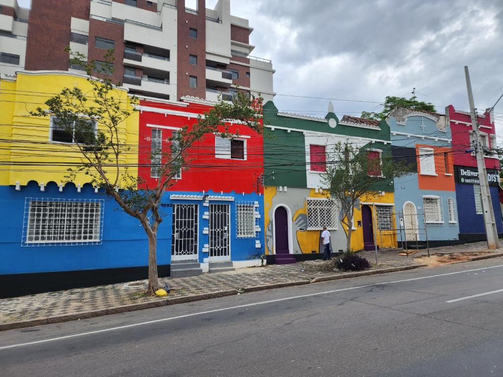 a row of colorful houses on the side of a street at Pousada Solar de Mayo in Curitiba