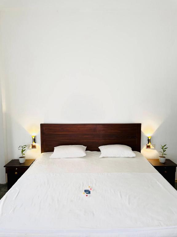 a bedroom with a large bed with two night stands at FA Resort in Panama