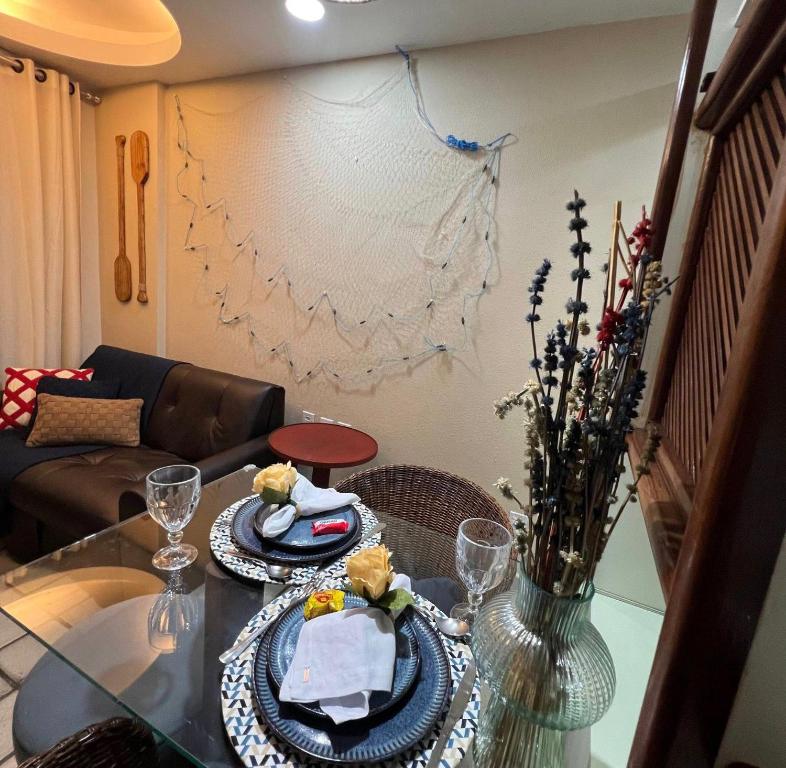 a living room with a table with plates of food at Apt Areia e Maré in Maceió