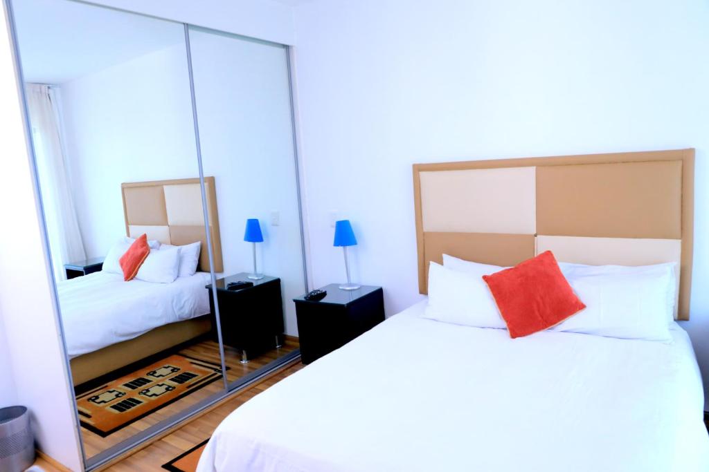 a bedroom with two beds and a large mirror at Grand View B&B in Johannesburg