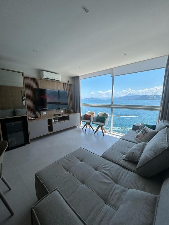 a large living room with a large bed and a television at Vilella Vista Bela in Angra dos Reis