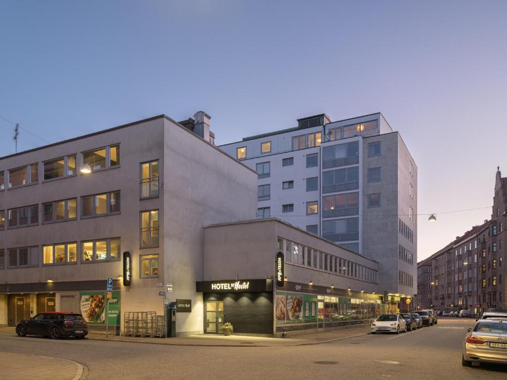 a building on a street with cars parked in front of it at HOTEL N Hostel Malmö City in Malmö