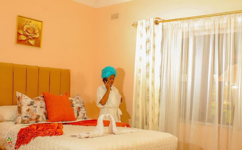 a statue of a woman sitting on a bed at Lion Haven Guest House in Harare