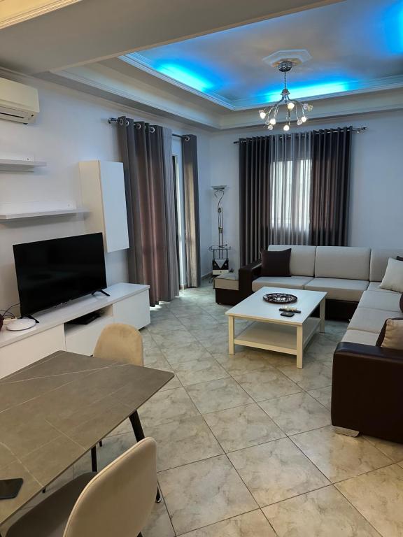 a living room with a couch and a table at Guesthouse Enea in Durrës