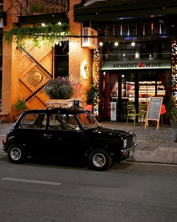 a small black car parked in front of a store at DAY & NIGHT by THE MOMENT in Chiang Mai