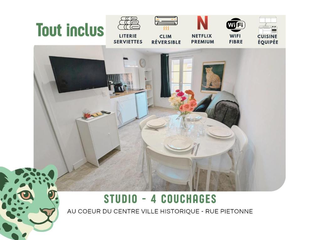 a room with a white table and a kitchen at Léopard vert - Clim - Tout inclus in Aubagne