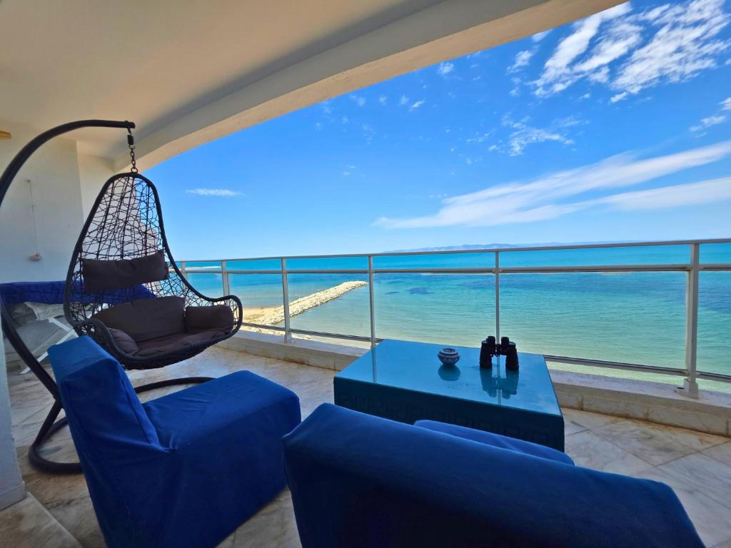 a living room with a hammock and a view of the ocean at La perle bleue in La Goulette