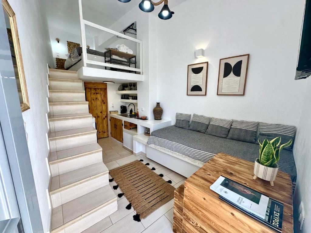 a bedroom with a bed and a stair case at Babatseratsi skyrian studio 2 in Skiros