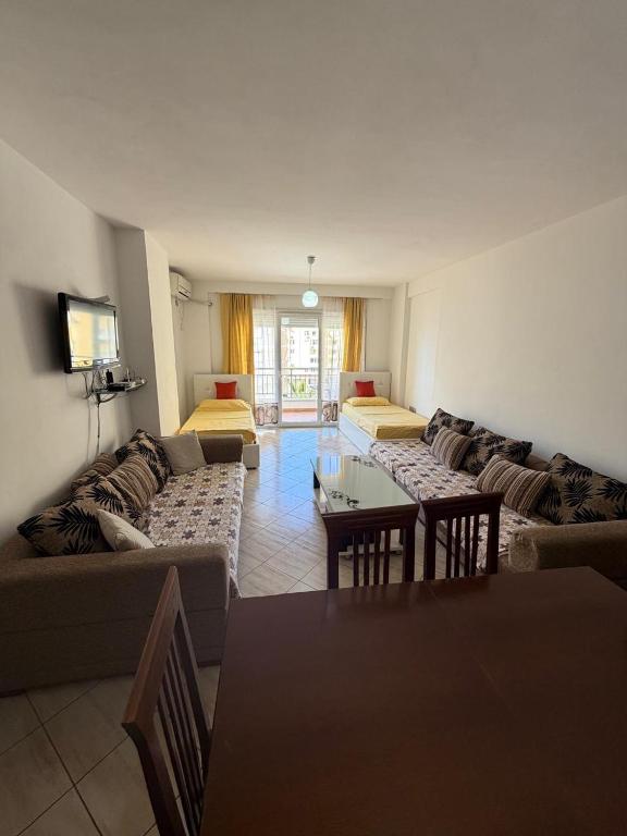 a living room with a couch and a table at Aldi APARTMENTS in Lezhë