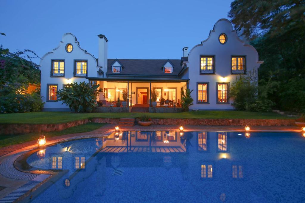 a house with a swimming pool in front of it at Karen Gables in Nairobi