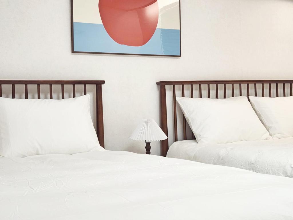 two beds sitting next to each other in a bedroom at Check in Seoul in Hongdae 2 in Seoul