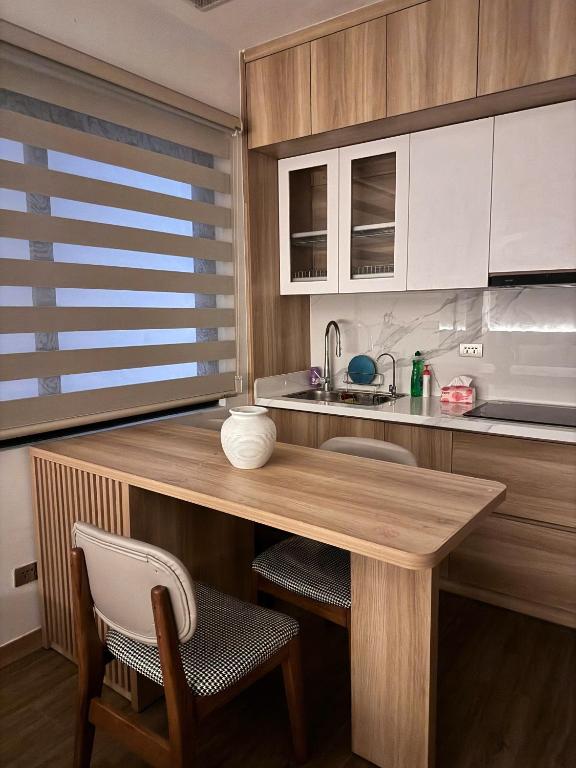 a kitchen with a wooden table and a sink at Maison du nook in Hanoi