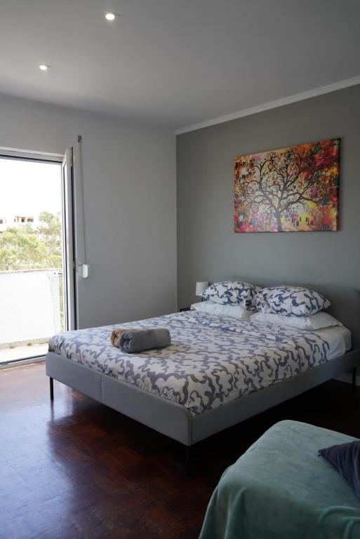 a bedroom with two beds and a painting on the wall at Sea Breeze Apartment in Lagos