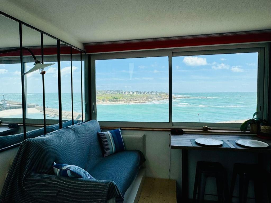 a living room with a couch and a table at Appartement duplex vue mer in Audierne