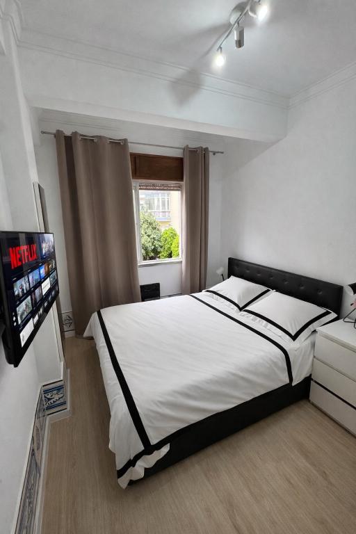 a bedroom with a bed and a tv in it at Double Room near Sintra & Lisbon in Queluz