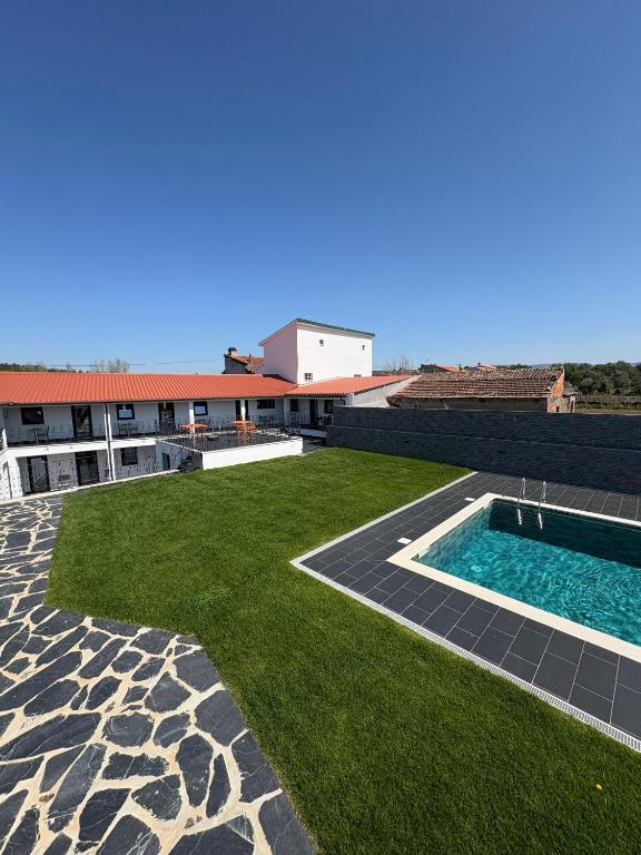 a large yard with a swimming pool on top of a building at Ribeirinha in Lousã