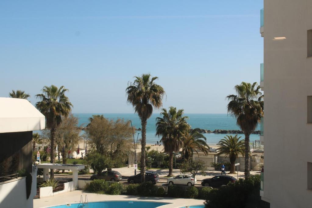 a view of the beach from the balcony of a building at Perla dell'Adriatico in San Benedetto del Tronto