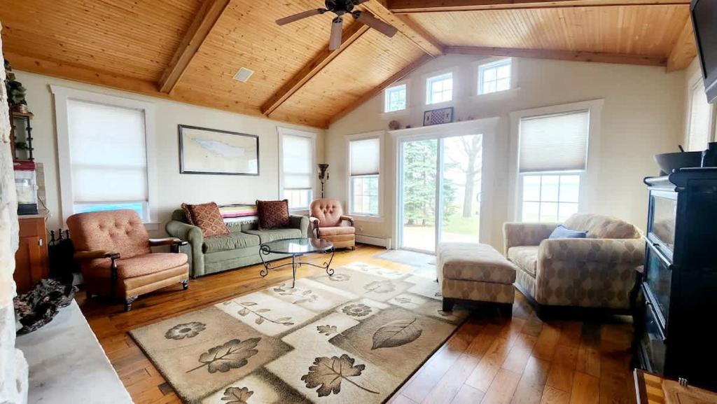 a living room with a couch chairs and a table at The Fireside Lakehouse in Bridgeport
