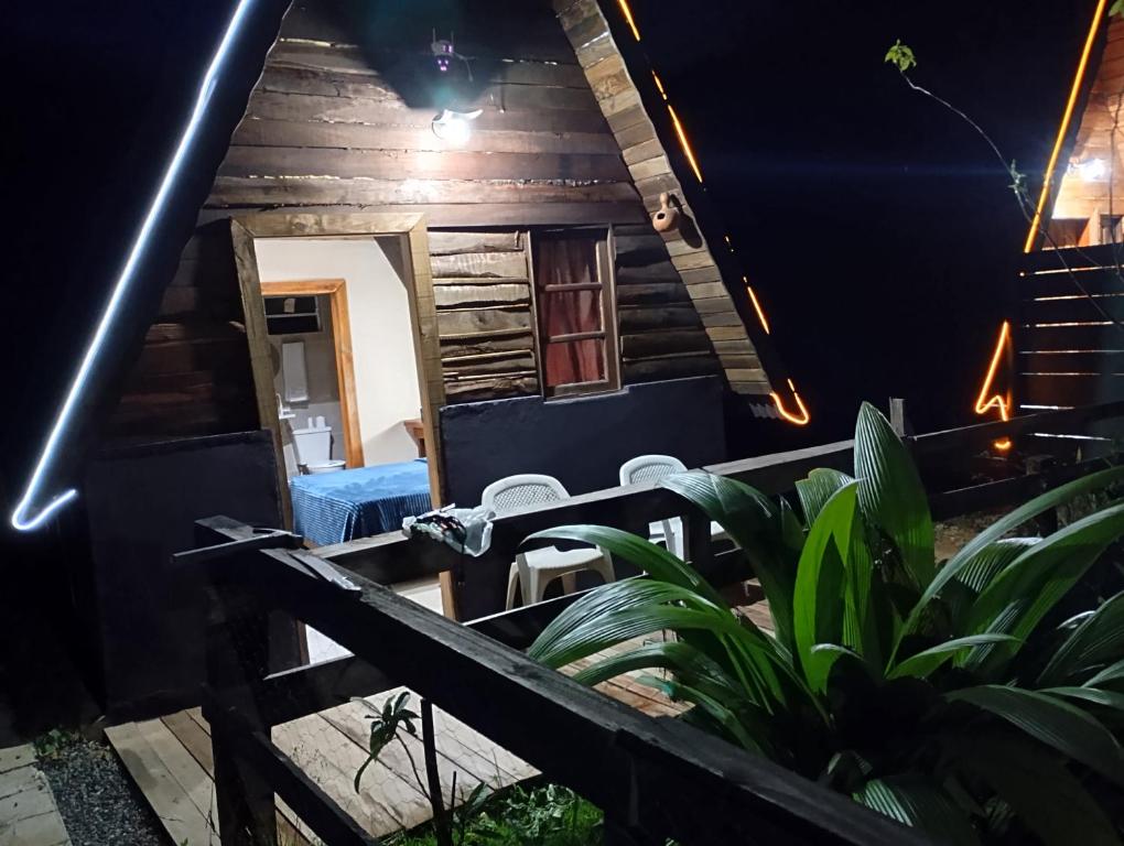 a view of the porch of a house at night at Chalés FRONT LAKE 2 in Córrego do Bom Jesus