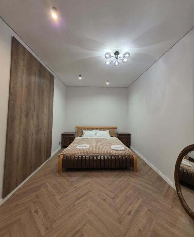 a bedroom with a bed in the middle of a room at Franko Aparts in Uzhhorod