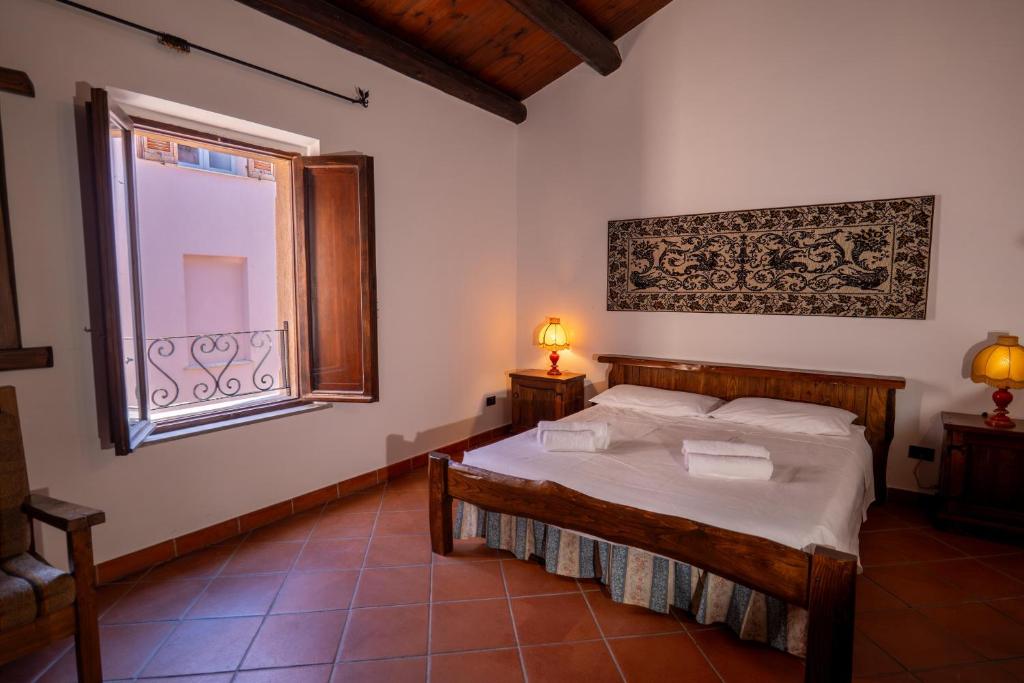 a bedroom with a bed and a window at Casa Milly in Alghero
