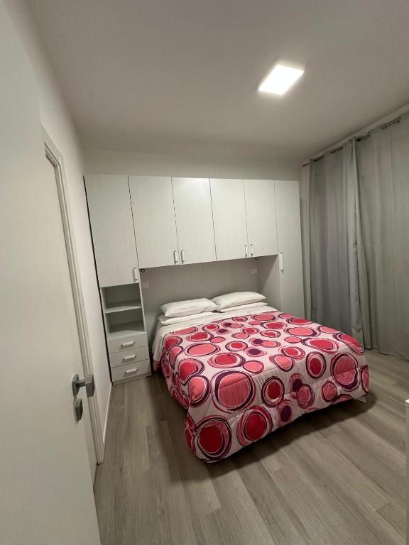 a bedroom with a bed with a red blanket at Prestige House 9 in Scalea