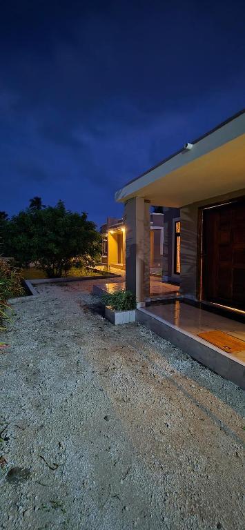 a house with a driveway in front of it at night at Mihambos Apartments in Msambweni