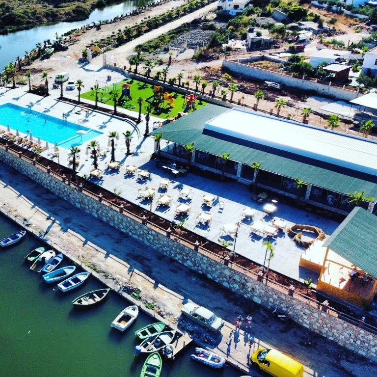 an aerial view of a marina with boats in the water at Hotel Lake Park Ksamil in Ksamil