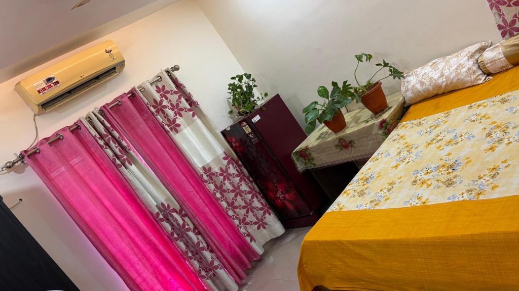 a bedroom with a bed and a window with curtains at VISHNOO STAYS Sunny Morning Room in Nawāgaon