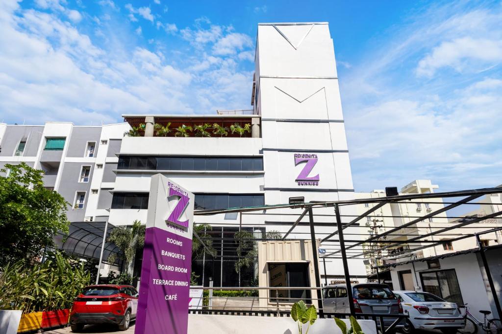 a white building with a sign in front of it at Regenta Z Sunrise Gachibowli, Hyderabad in Kondapur