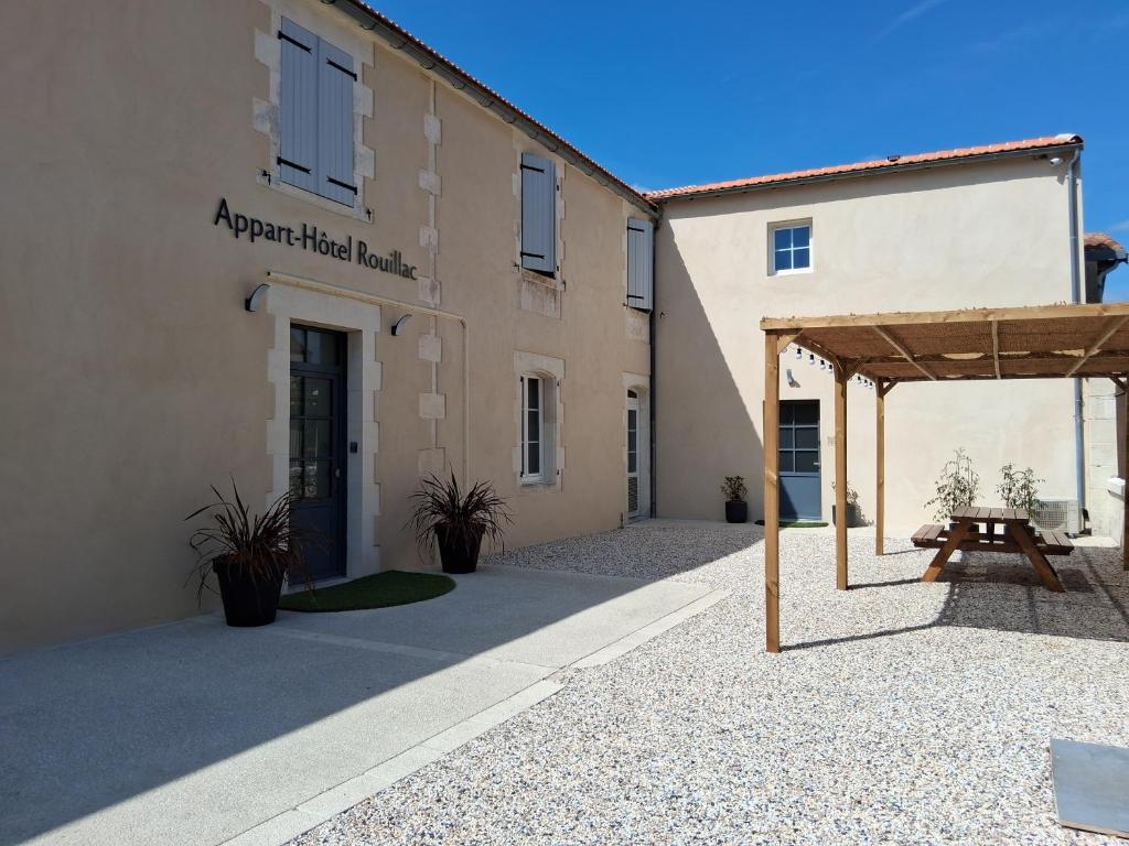 a building with a picnic table in front of it at Appart-Hôtel Rouillac in Rouillac