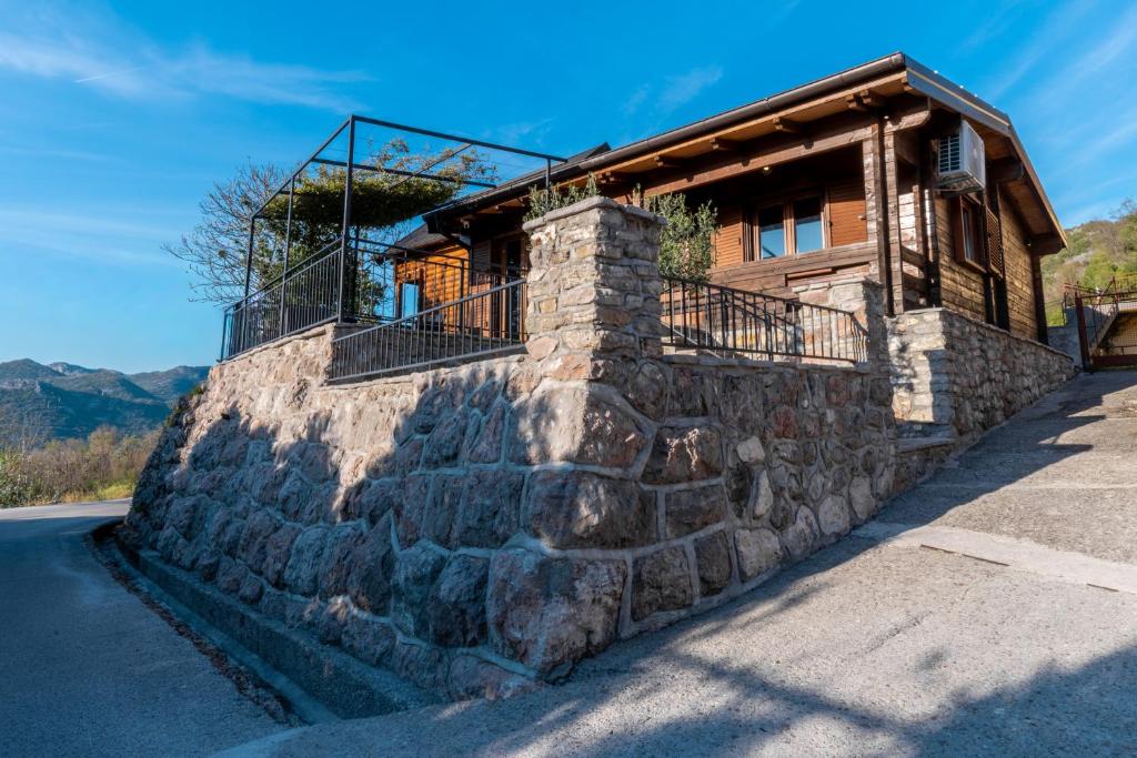 a house on a stone wall next to a road at Zabes Home in Zabes