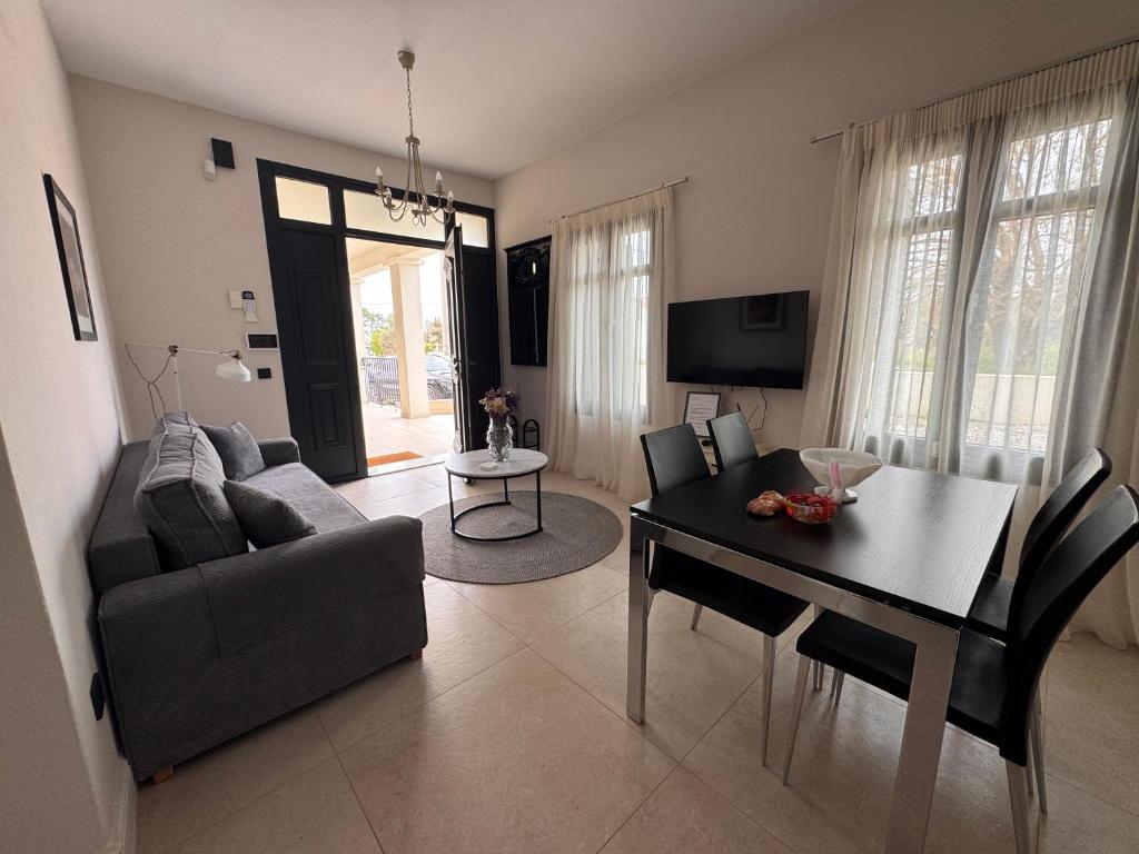 a living room with a couch and a dining room table at The Mulberry House Heritage by the Sea in Alexandroupoli