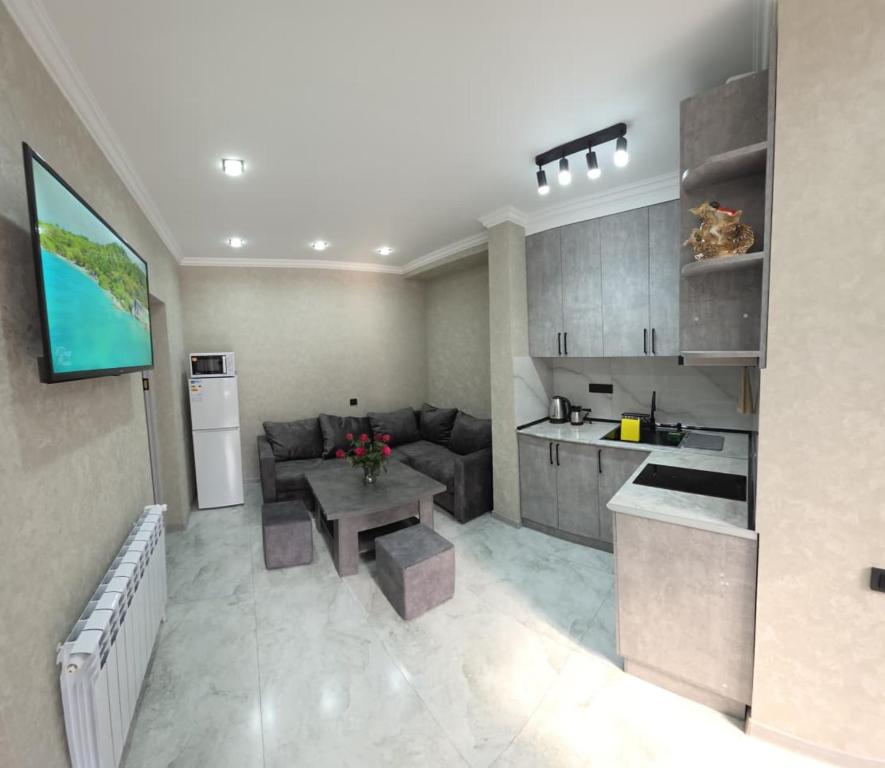 a kitchen and living room with a couch and a table at Livana Guesthouse - Goris in Goris