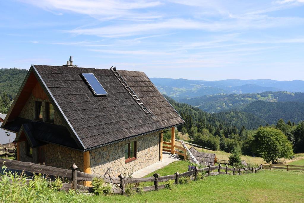a house with a solar panel on the roof at Domek u Johnnego 28 in Piwniczna Zdrój