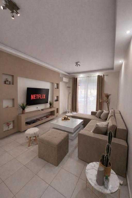a living room with a couch and a tv at Rhodes Nest in Ixia