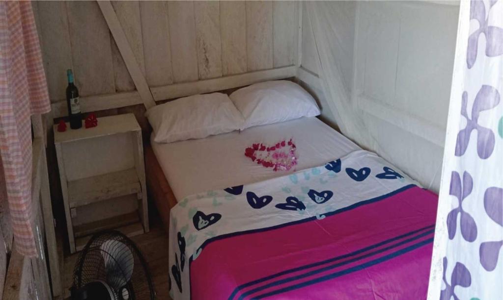 a small bedroom with a bed in a tent at Cabaña Luna Nueva in Buenaventura