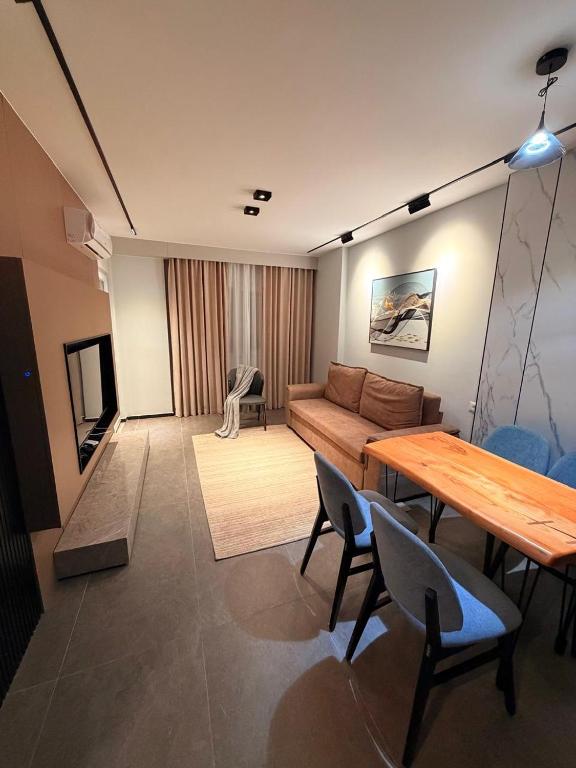 a living room with a couch and a table at Casa Del Sol - Shengjin in Shëngjin