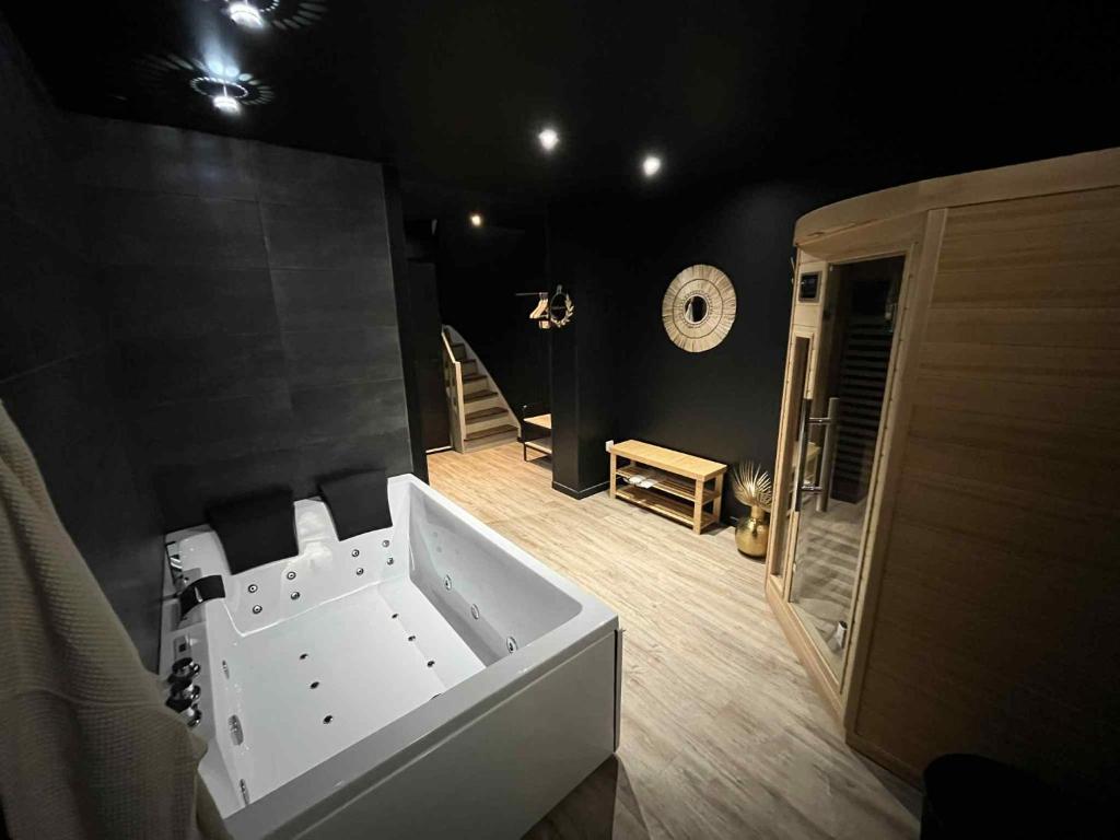 a bathroom with a white tub in a room at Fleur de Lune in Amiens