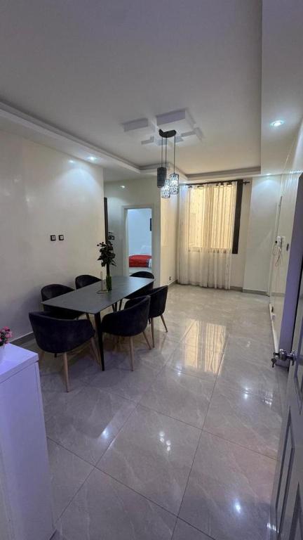 a dining room with a table and chairs in a room at World Prestige Properties in Dakar