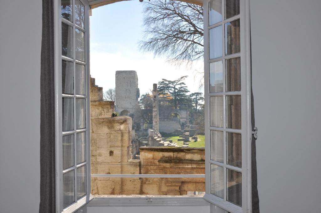 an open window with a view of a city at Holiday in Arles -Appartement du Théâtre Antique in Arles