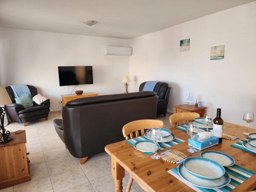 a living room with a table and a couch at Argaka Breeze sea view apartment in Argaka