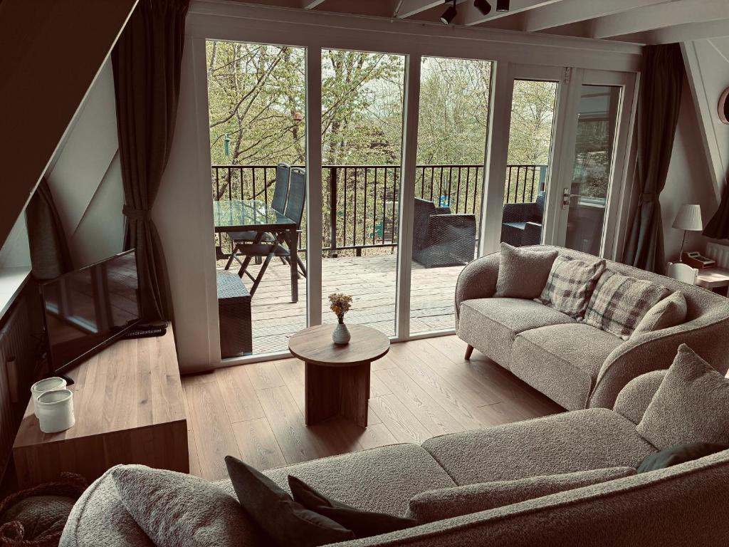 a living room with a couch and a table at Chalet AchiLou in Durbuy