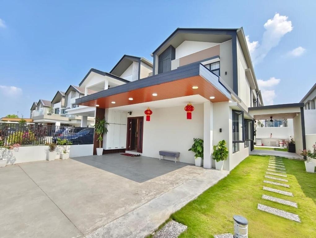 a house with a courtyard in front of it at Mallow Semi-D homestay in Rawang