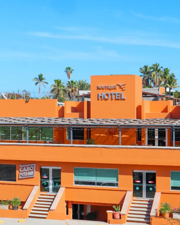 an orange hotel with a sign on top of it at Hotel Boutique Plaza Doradas in San José del Cabo