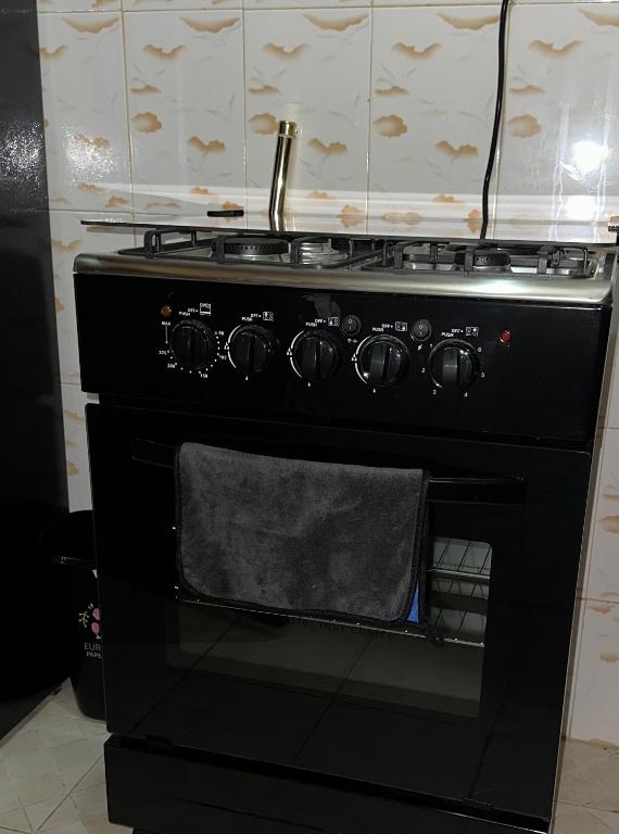 a black stove with a towel on the oven at ZulynHomes in Kisumu