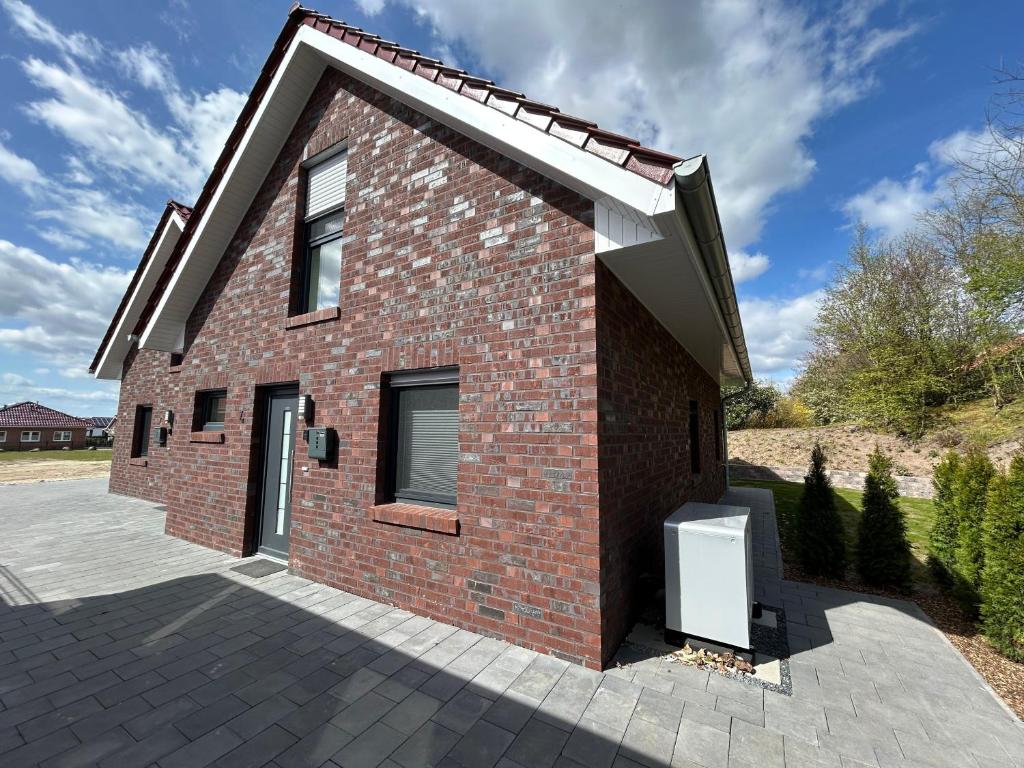a red brick house with a driveway at Seebrise in Geeste